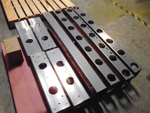 Caster beams for modular rack fabrication using simple bolt together components